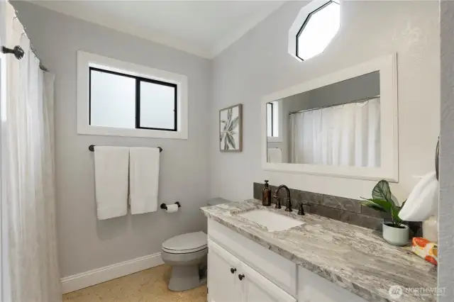 Upstairs' full bath with Quartz counters  & tiled floors.