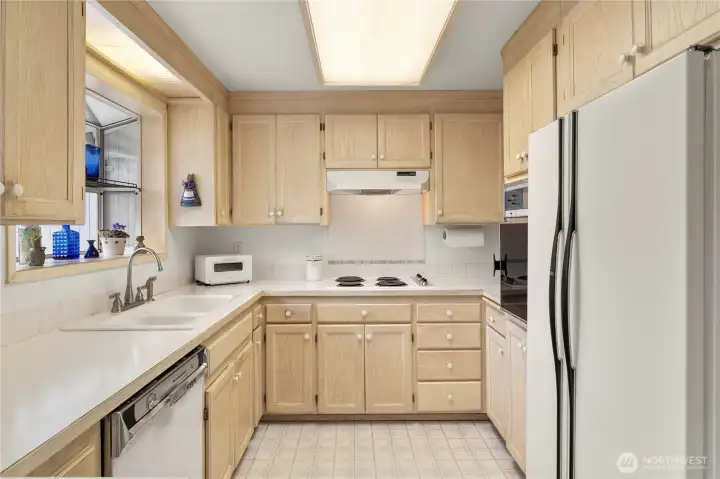 Kitchen with ample cabinet space & backyard views