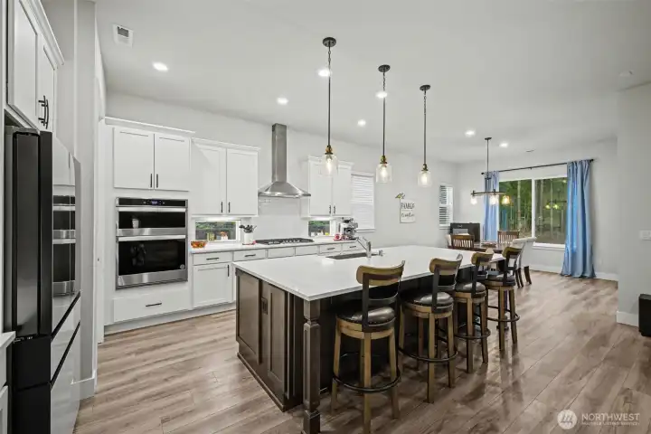 A truly practical kitchen with quartz counters and tons of storage, including double-sided cabinets in the island and a walk-in pantry that keeps everything right where you need it. This is the kind of space that actually makes life easier.
