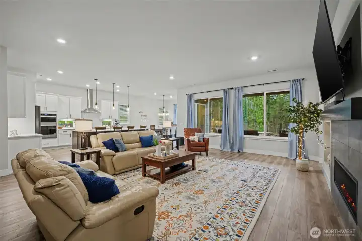 An expansive living area filled with natural light from oversized windows, creating a bright, open feel that truly sets this space apart.