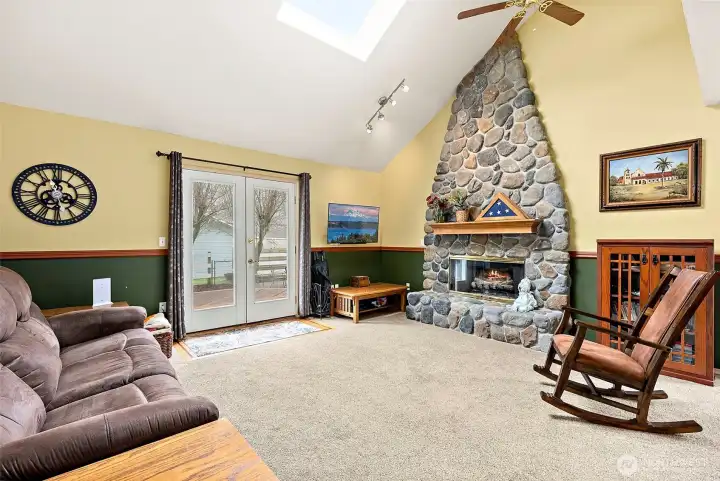 The rock fireplace is a showstopper with the vaulted ceilings