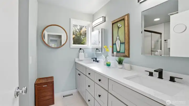 Newly updated full bath with two separate vanity areas and a tub/shower with glass doors—perfect for busy mornings