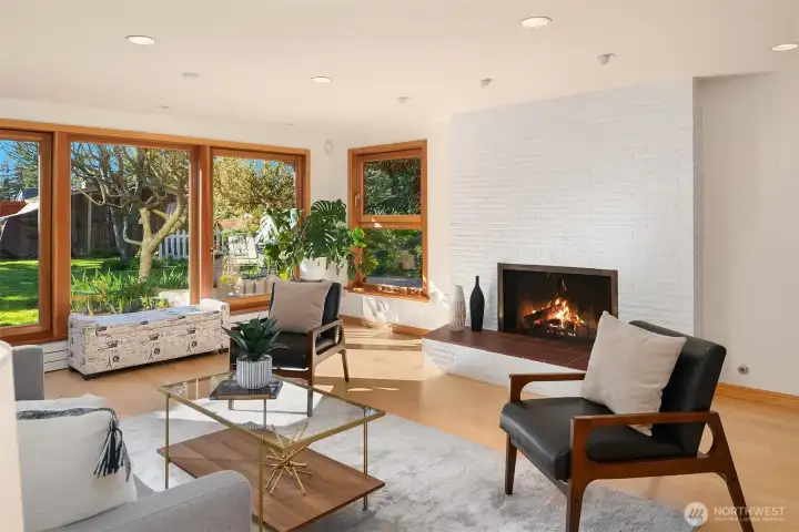 Lower Level Family Room Features Floor to Ceiling Wood Windows, Western Facing Outdoor Living Spaces, Wood & Gas Fireplace, Hardwood Flooring and Recessed LED Lighting