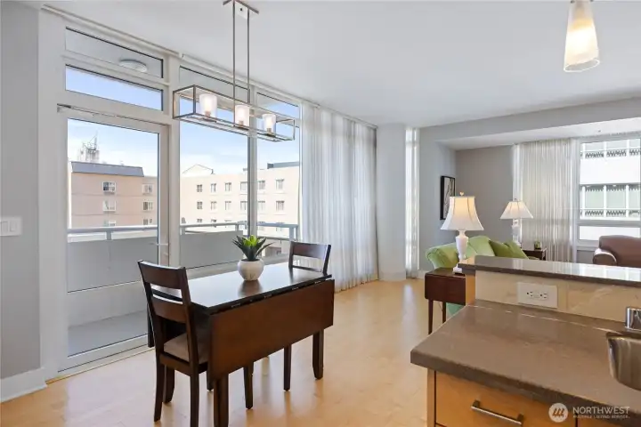 Dining area has a glass door for access to a deck facing the City and Shipyard.