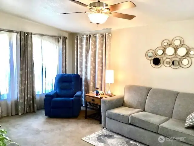 Spacious and open living room with ceiling fan