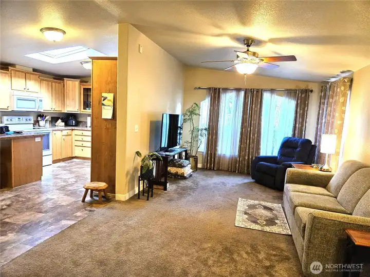The living room flows into the dining room and kitchen.