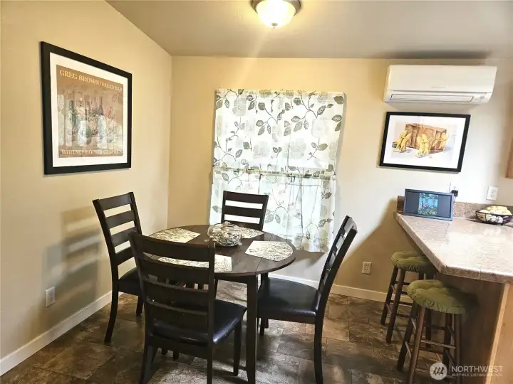 The dining room is located just off the living room and kitchen, and features a convenient eating bar.