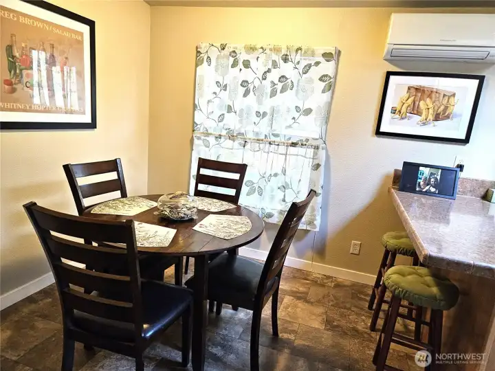 The dining room is located just off the living room and kitchen, and features a convenient eating bar.