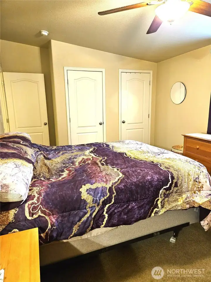 Generous primary bedroom featuring a c and two roomy closets.