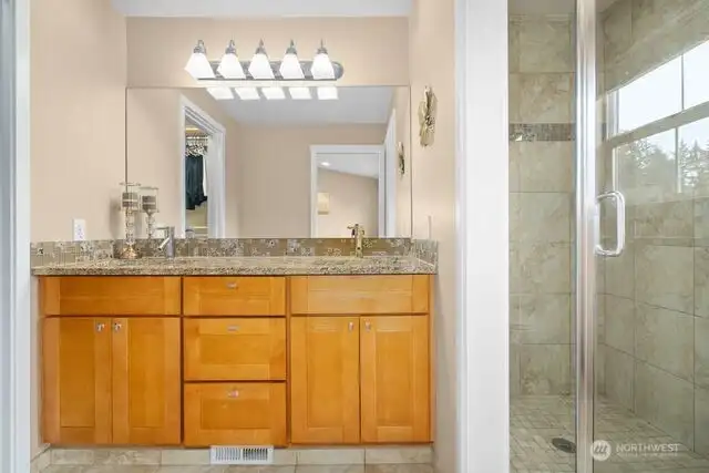 Primary bathroom with walk-in shower and walk-in closet