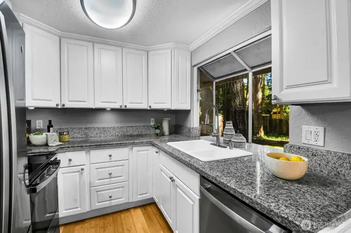 All new cabinets, GE Profile appliances, granite countertops, bamboo flooring (throughout) with bright Bay window to overlooks (south) into activity in the expansive backyard, patio, fountains, reflection pond, lawn.