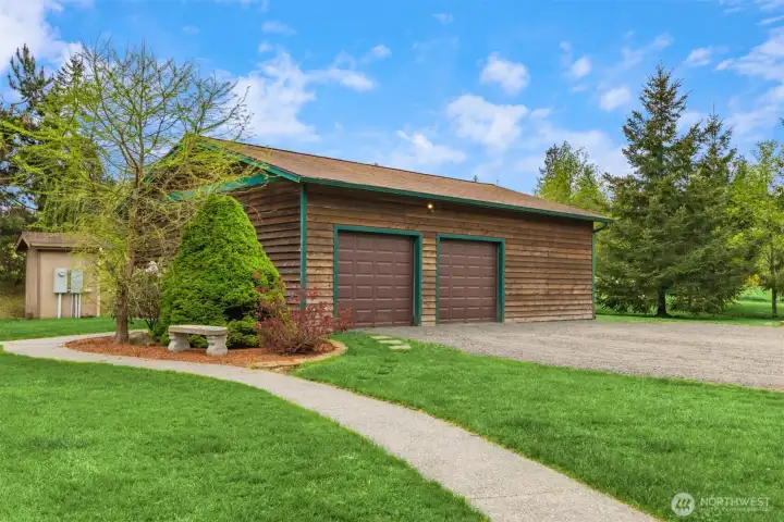 Detached 1008 sq ft garage with shop space and a wood fireplace.