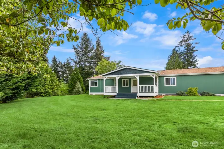 A lush lawn and mature landscaping surrounding the home gives a "park like" feeling.