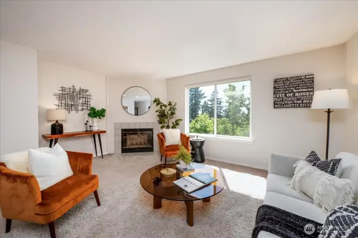 Spacious living room has views of the Olympics on a clear day.