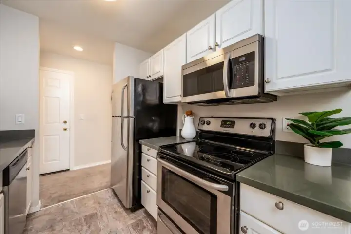 Kitchen updated with quartz countertops and stainless steel appliances.