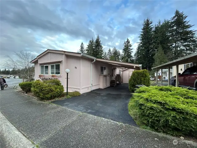 Large carport giving access to utility room