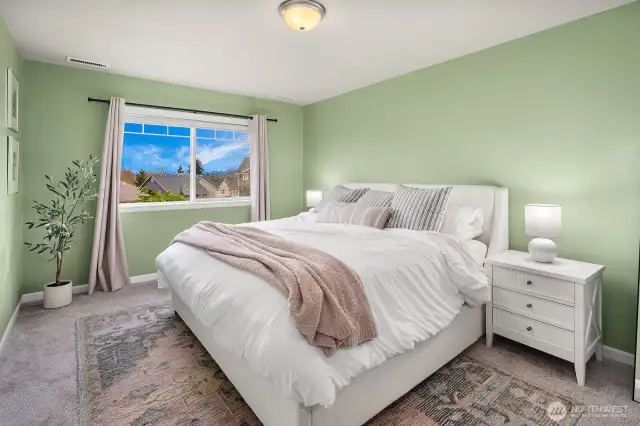 Spacious Primary Bedroom has adjoining luxurious bathroom with dual sinks, tile shower and large walk-in closet with dual sided built in rods and shelving. Big picture window provides partial Cascade Mountain & Seattle Skyline views.