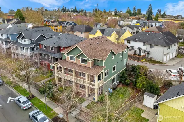 Ariel view of home shows street entrance, fenced front and side yards and alleyway behind home.