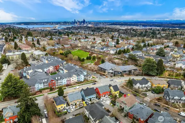 Ariel view over home facing North East shows community center, park and Seattle Skyline.