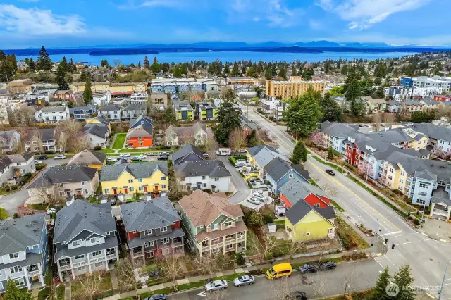 Ariel view facing West shows Alki Beach, bay, and Olympic mountain views.