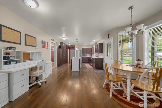 Large kitchen with eating, center island and desk/office area.