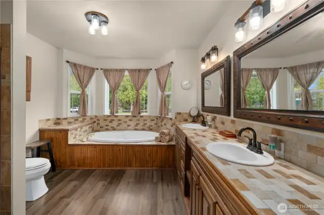 Upper Level 1 - Main Bath features large double sink vanity, soaker tub, shower and ample storage.