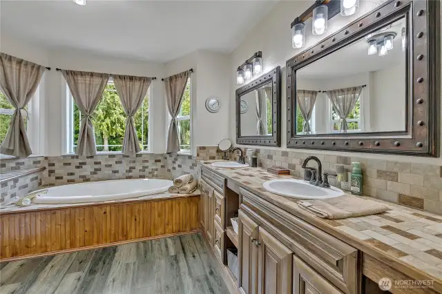 Upper Level 1 - Main Bath features large double sink vanity, soaker tub, shower and ample storage.