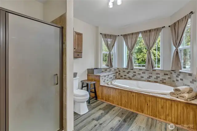 Large soaker tub overlooks the landscaped backyard. This bath also has a separate shower.