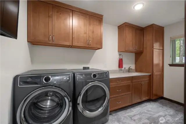 Utility room - W/D raised up on platform. Storage abounds.