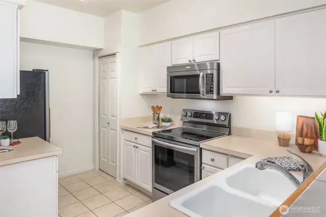 Stainless steel appliances and a pantry in the kitchen.