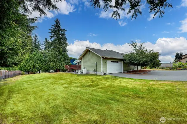 Side view of the yard and oversized garage