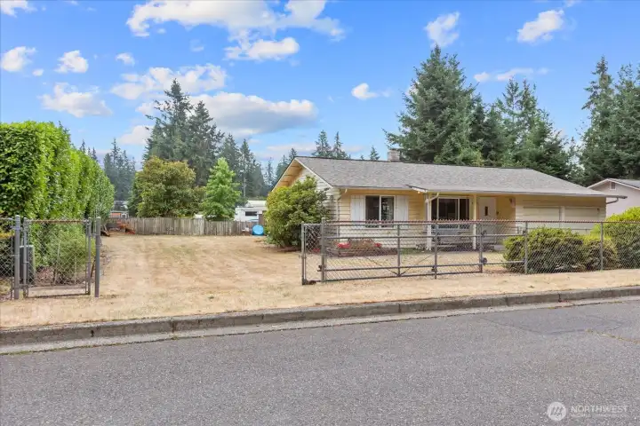 This generous 9,720 square foot lot is fully fenced, with RV parking and a large, expandable gate.