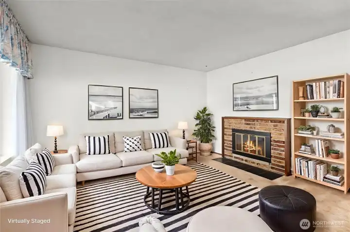 Welcoming main living area anchored by a wood-burning fireplace, perfect for cozy evenings.