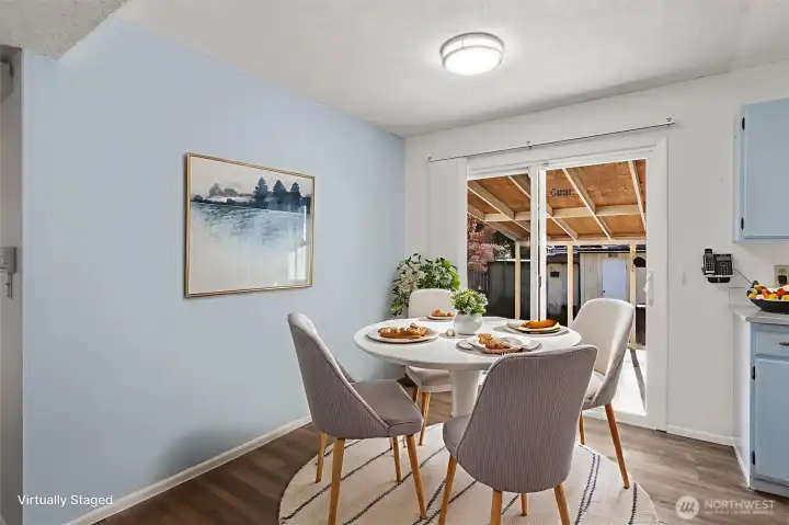 Dining area that opens to the kitchen, featuring durable and stylish updated LVP flooring.