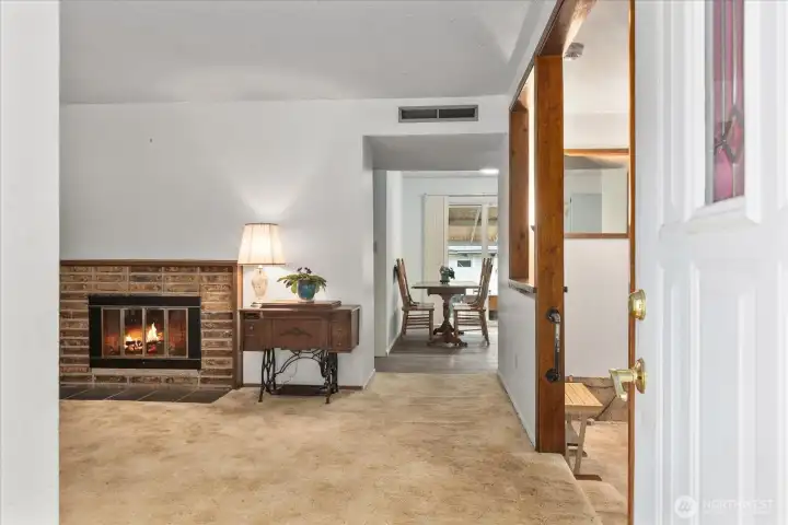 Enter to a welcoming main living area anchored by a wood-burning fireplace, perfect for cozy evenings.