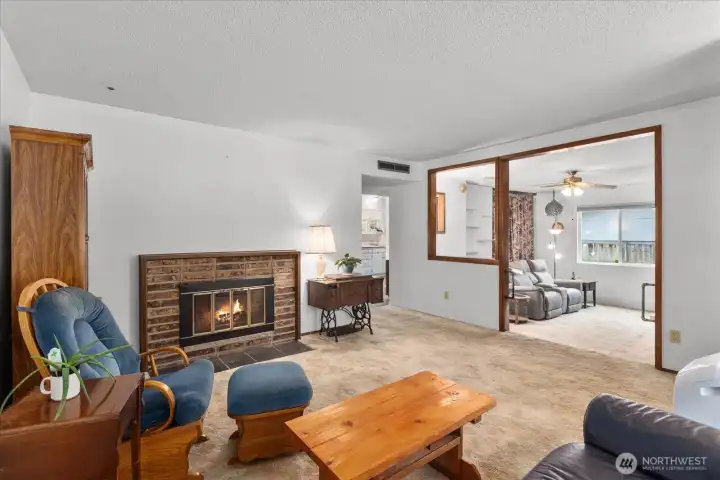 Welcoming main living area anchored by a wood-burning fireplace, perfect for cozy evenings.