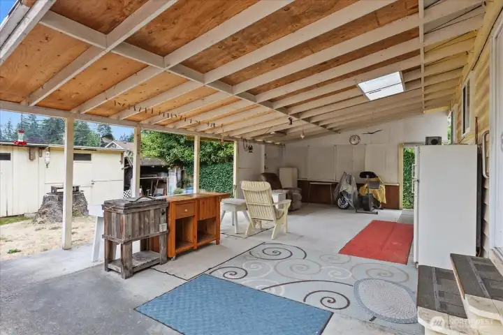 Enjoy outdoor living with a covered back patio, sheds for added storage, and space to garden or relax.