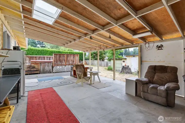 Enjoy outdoor living with a covered back patio, sheds for added storage, and space to garden or relax.