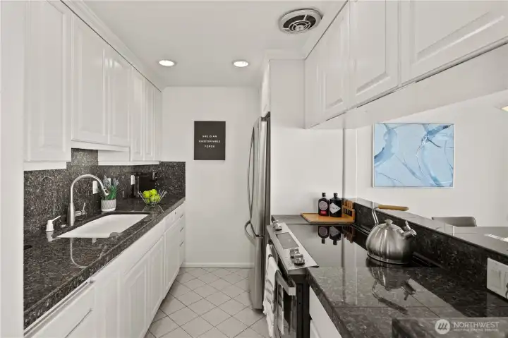 Everything is within easy reach in the kitchen with granite counter tops, new fridge and stove/oven.