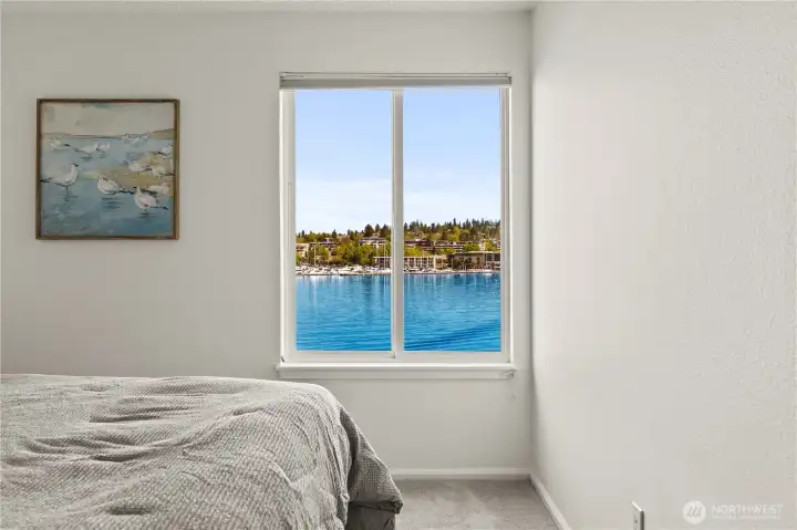 Second/guest bedroom features a view to the Kirkland Marina and lake.