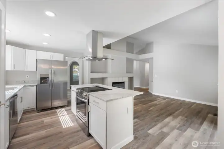 ~Gorgeous new kitchen with white cabinetry, quartzite countertops, stainless-steel appliances, a large island, and a pantry~