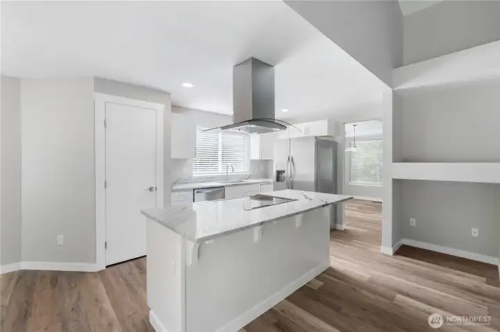 ~Gorgeous new kitchen with white cabinetry, quartzite countertops, stainless-steel appliances, a large island, and a pantry~