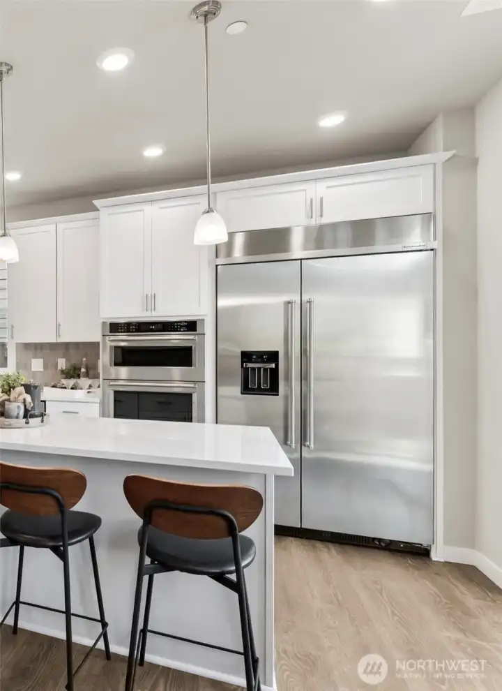 Showing the included built in refrigerator with water & ice feature. White cabinets are an option available to add early in the process.