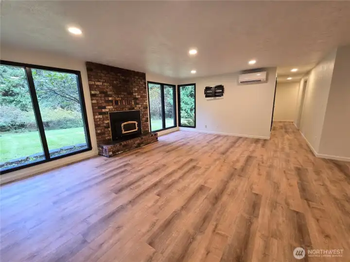 Open Living Area with Wood Fireplace and Ductless Heat Pump