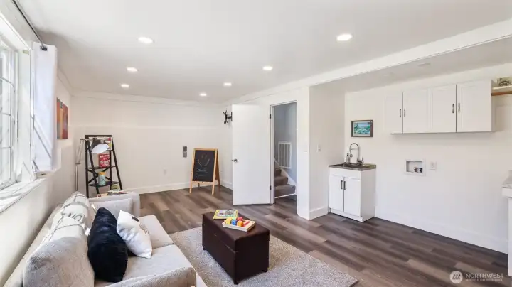 Washer and dryer plus utility sink in the bonus room on the lower level.