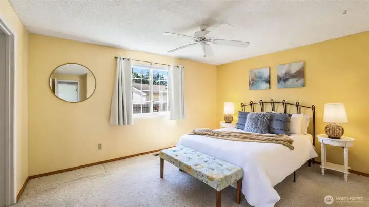 This spacious primary offers a walk-in closet, 3/4 bath en suite and space for a sitting area.