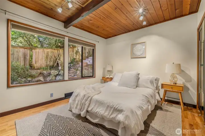 This corner bedroom features a wall filled with closet space.