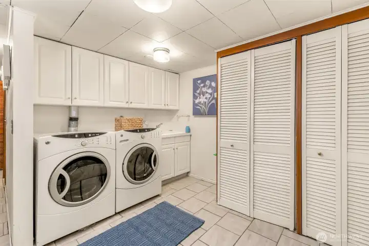 Large laundry room with endless closets for storage.