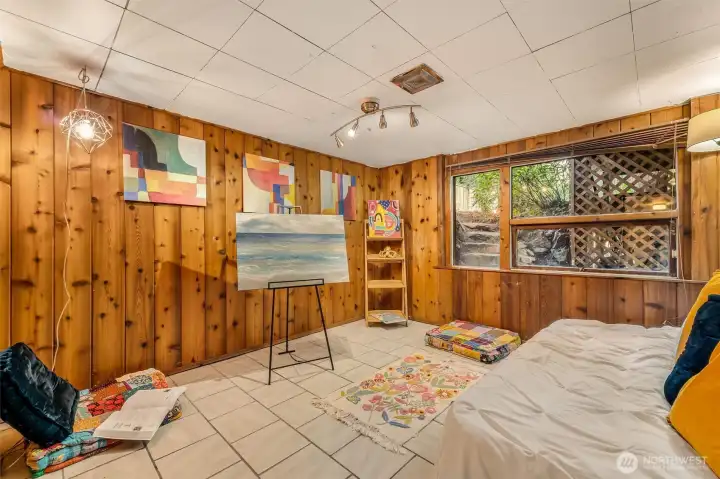The beautiful original wood paneling in this 4th  bedroom located on the lower level really makes it feel warm cozy.