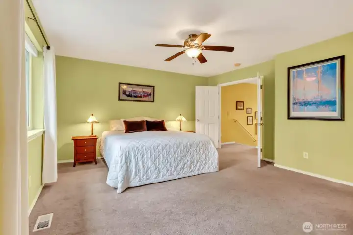 At the top of the stairs, French doors welcome you into a spacious primary suite with a unique and rare feature.